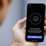 FILE PHOTO:  An attendee uses the Face ID function on the new iPhone X during a presentation for the media in Beijing