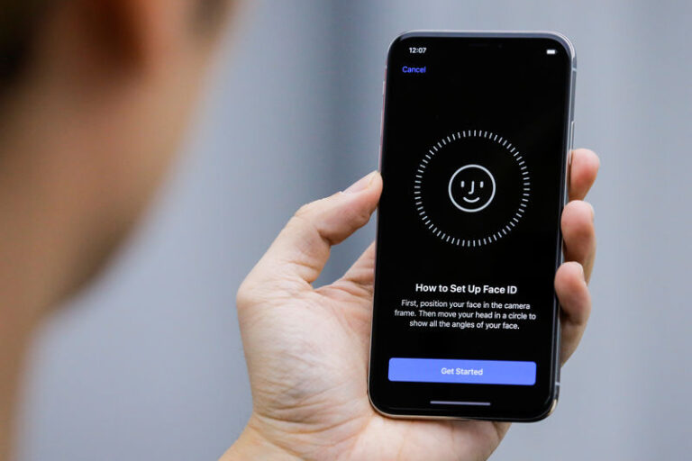 FILE PHOTO:  An attendee uses the Face ID function on the new iPhone X during a presentation for the media in Beijing