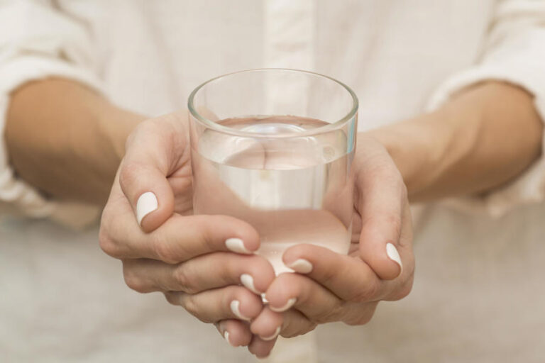 woman-holding-glass-filled-with-water